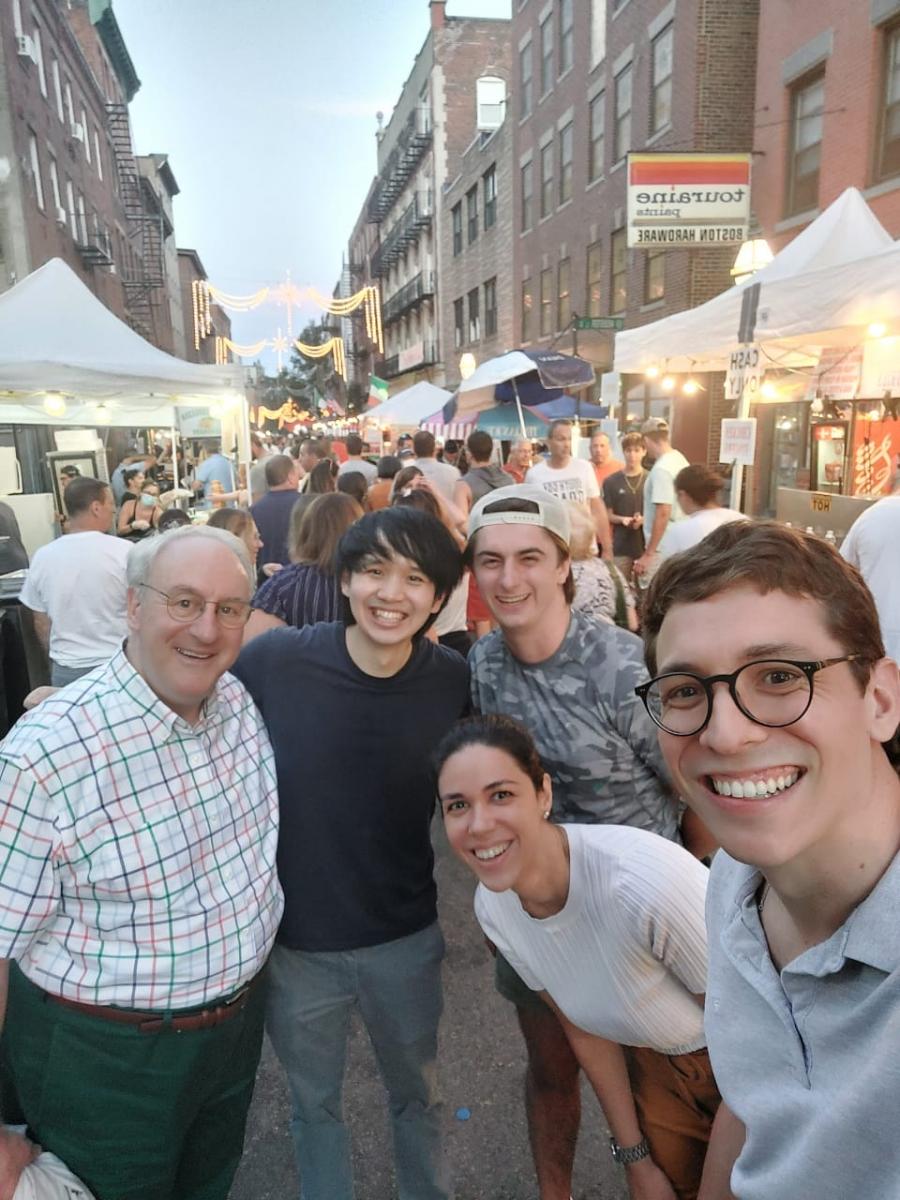 A host and students visiting Fisherman's Feast in Boston's North End